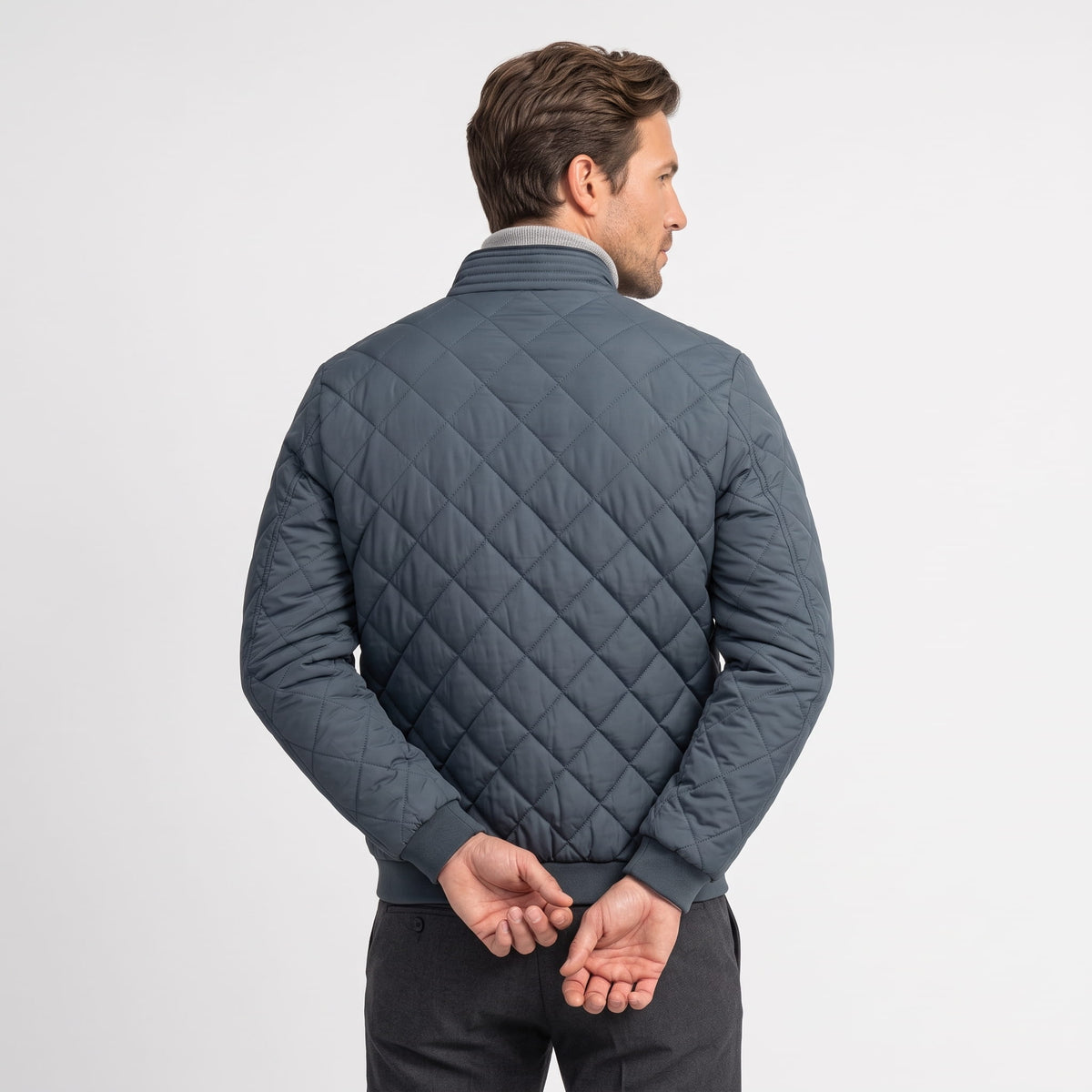 Back view of the slate blue colorway with diamond quilting and ribbed hem