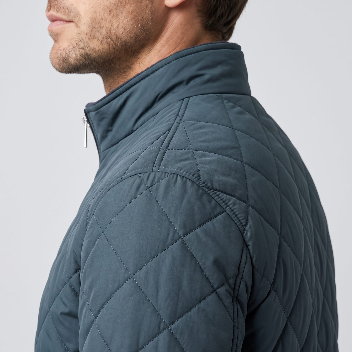 Close shoulder detail in slate blue showing the diamond stitch lattice