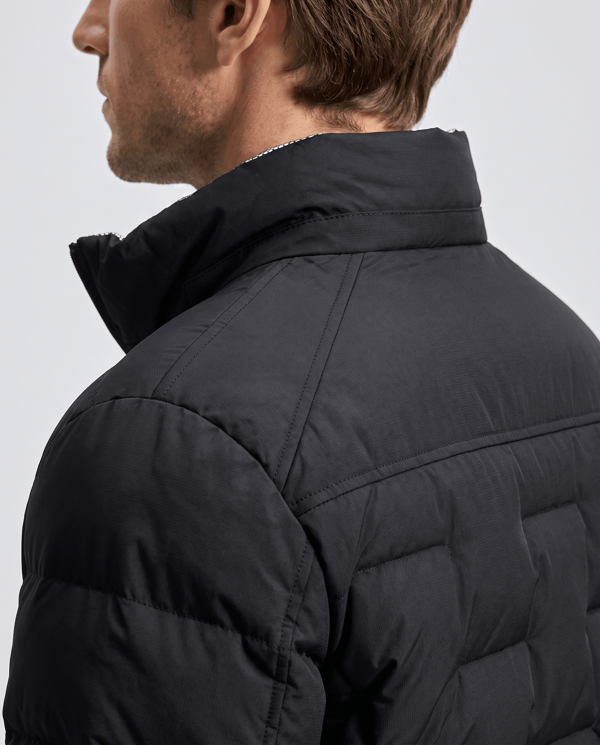 Rear collar detail on black, showing the upright collar and yoke seam