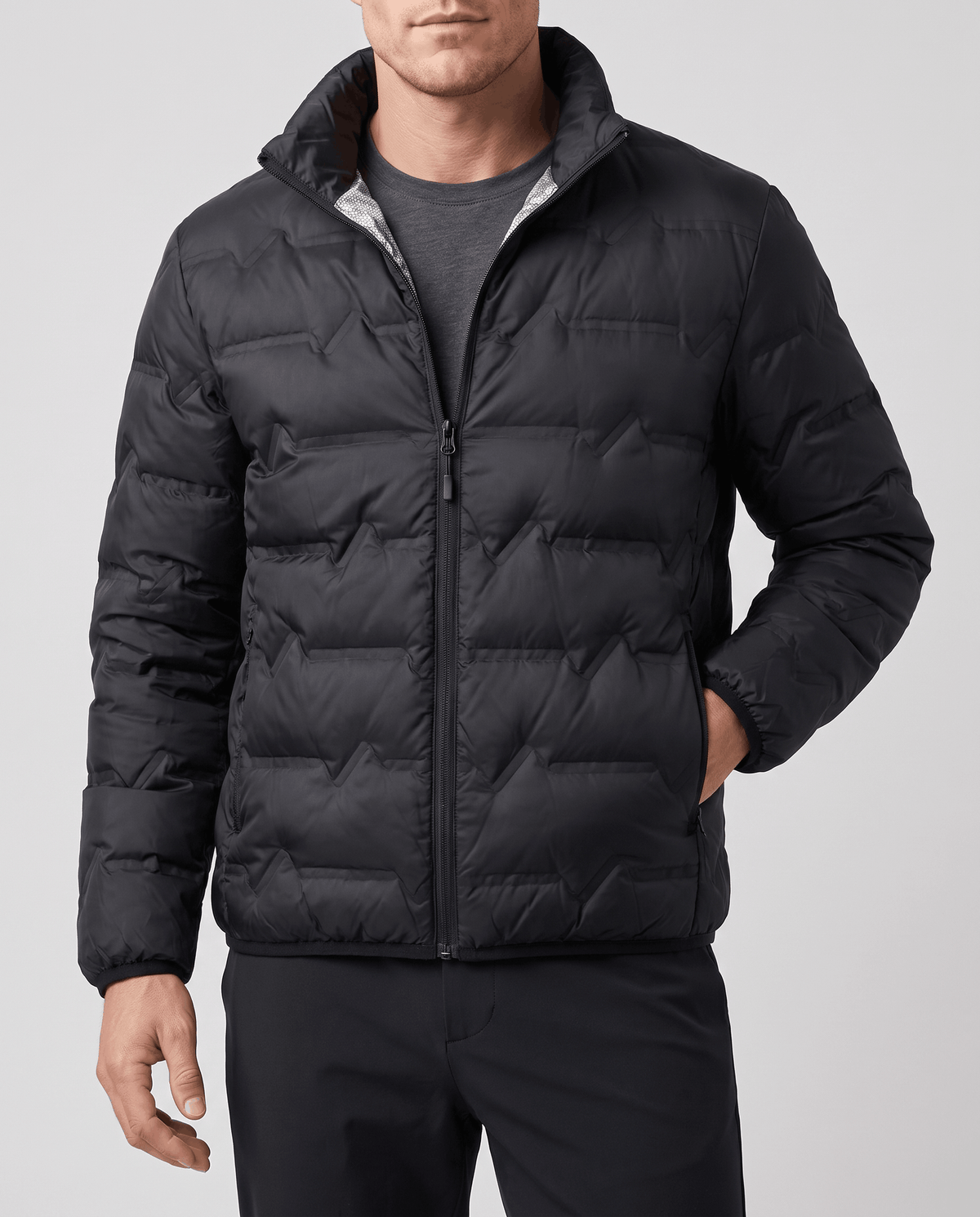 Black jacket over a gray crewneck, hand resting in the side pocket