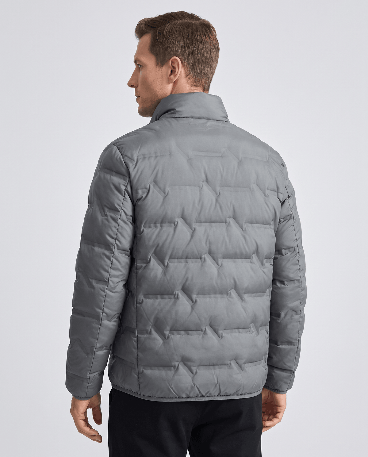 Back view of the gray jacket showing quilted panels and hip-length hem