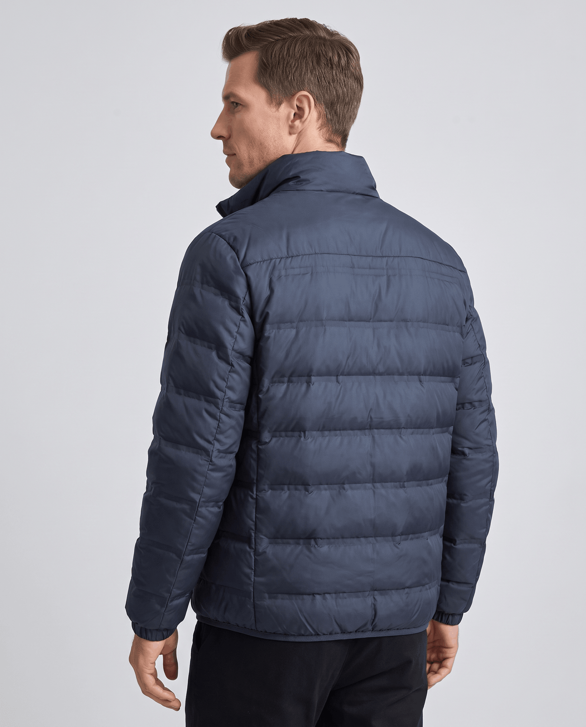Back view of the navy colorway showing collar, shoulder seam and quilted panels