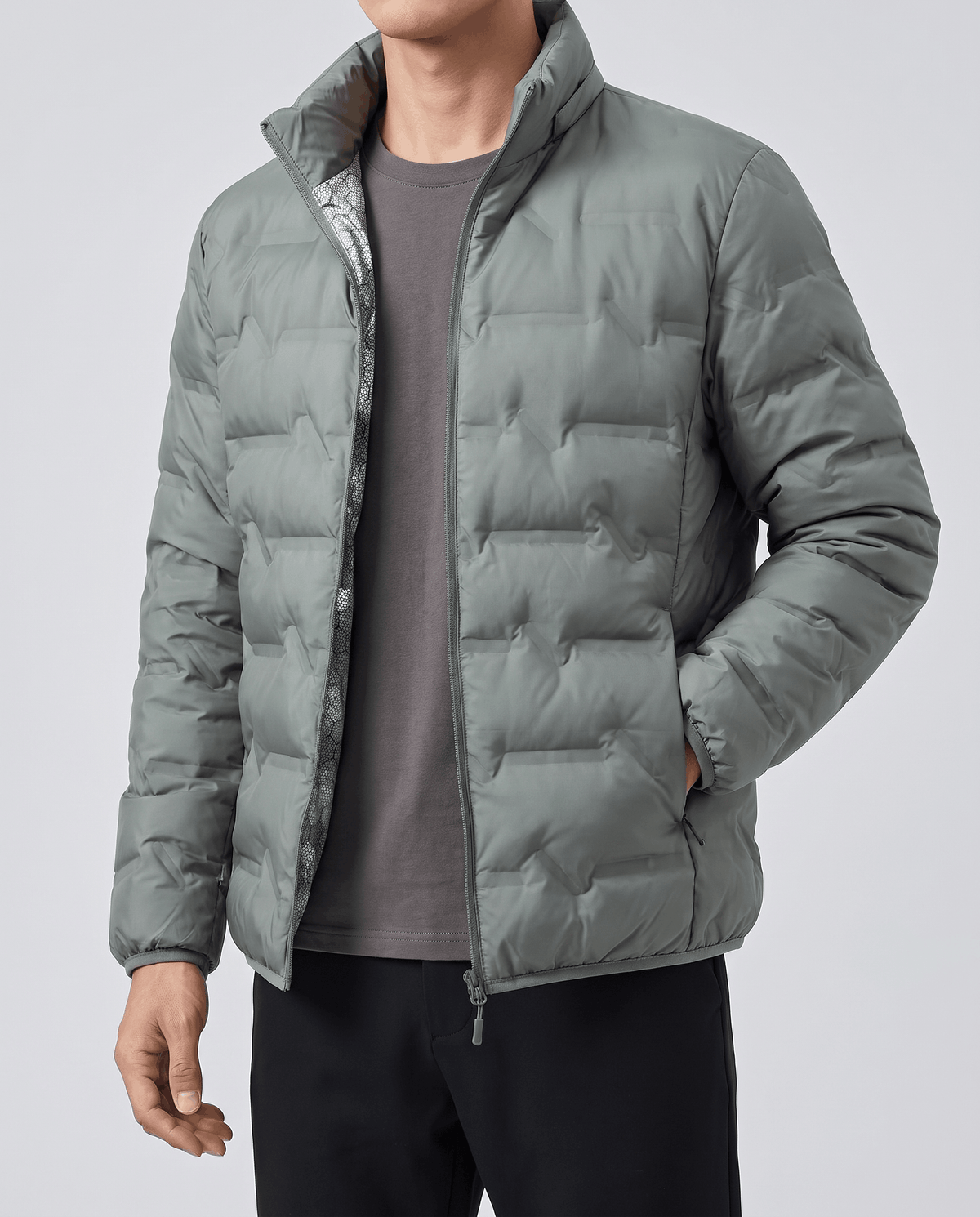 Olive jacket unzipped over a gray crewneck, showing the pale inner lining
