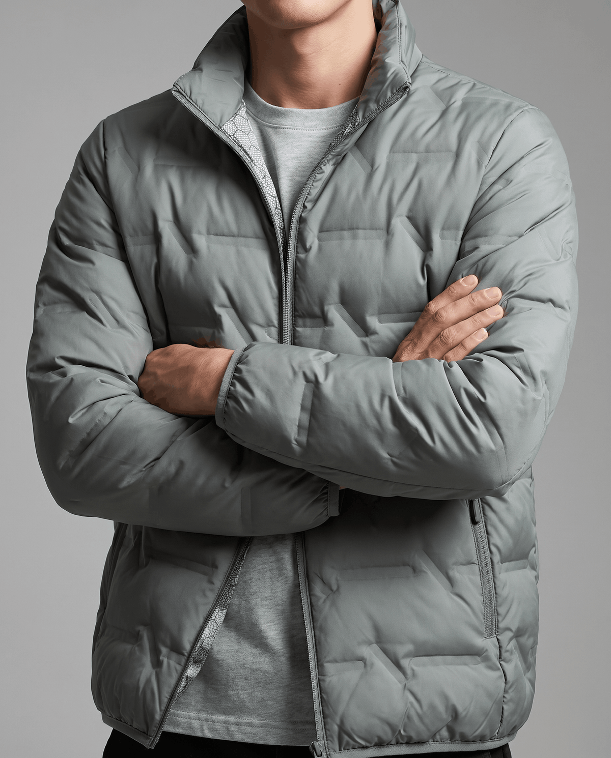Olive jacket with arms crossed, quilted chest panels and raised collar in view