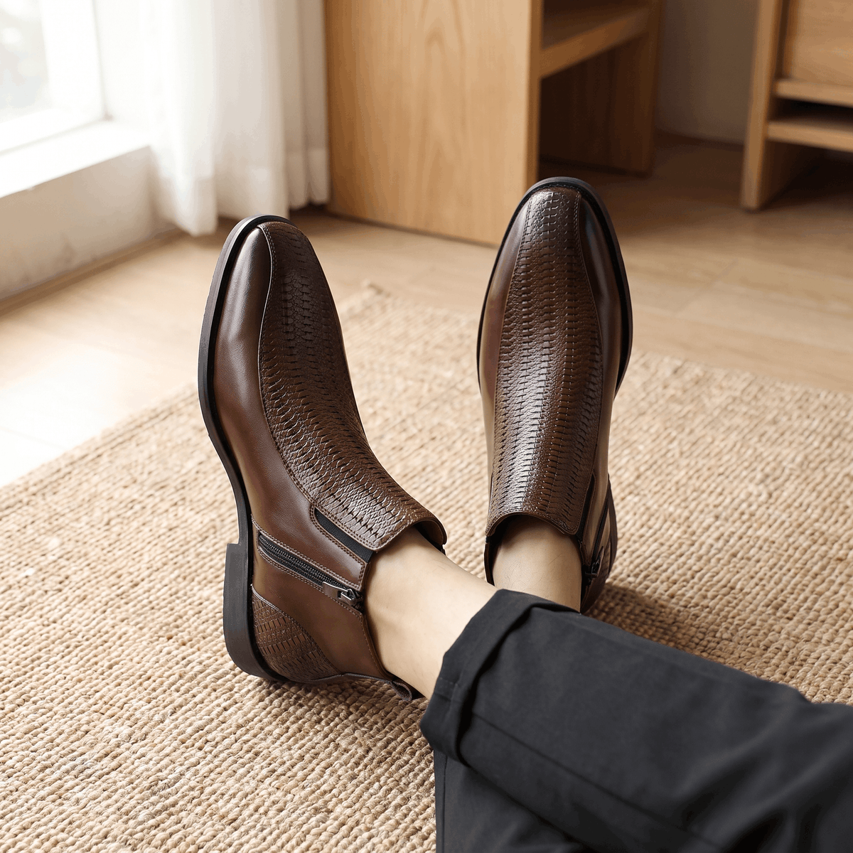 Brown leather ankle boots featuring a basketweave embossed quarter panel, side zip closure, and a softly squared toe.
