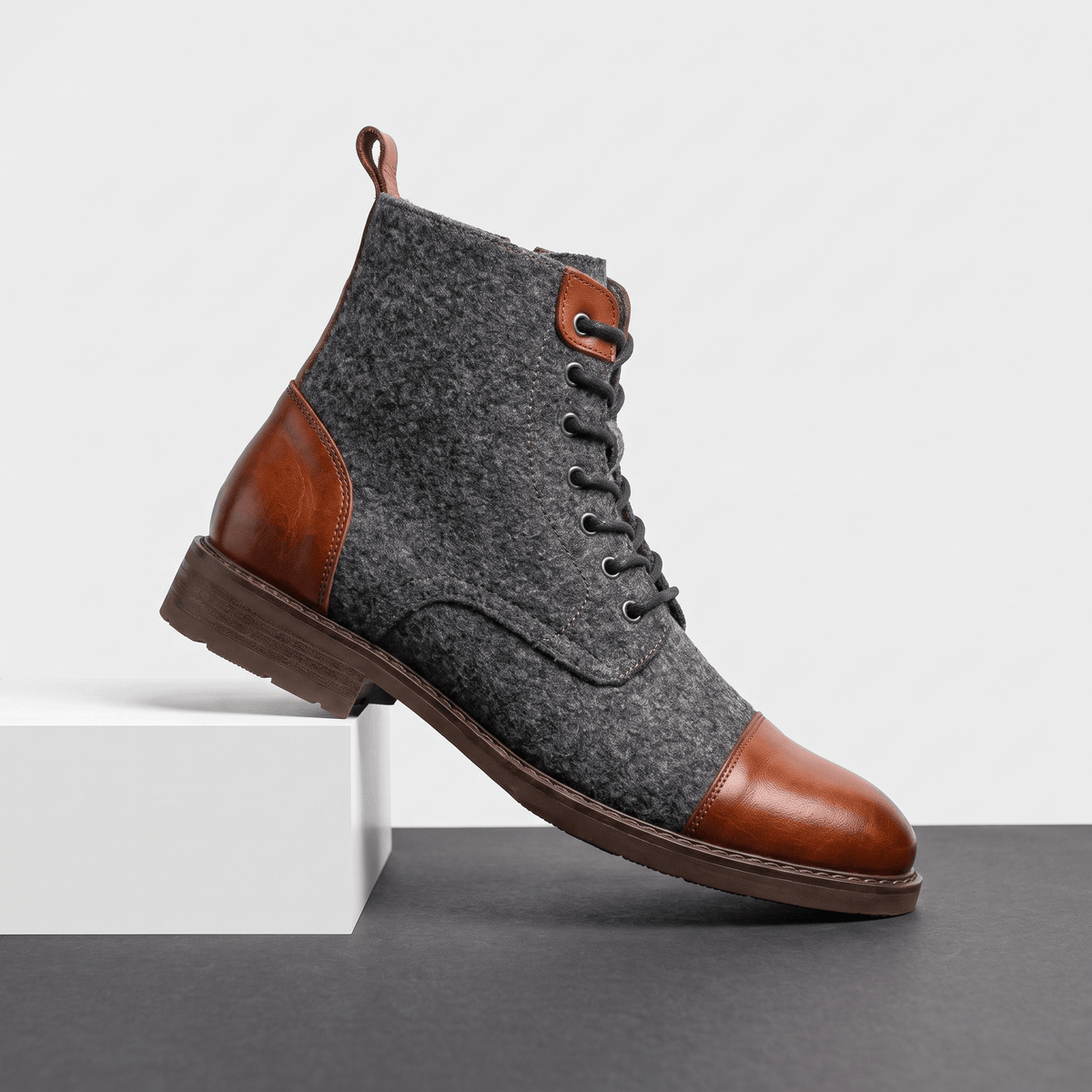 Brown felted wool cap toe boot with polished brown leather trim, seven-eyelet lacing, and a durable welted rubber sole.