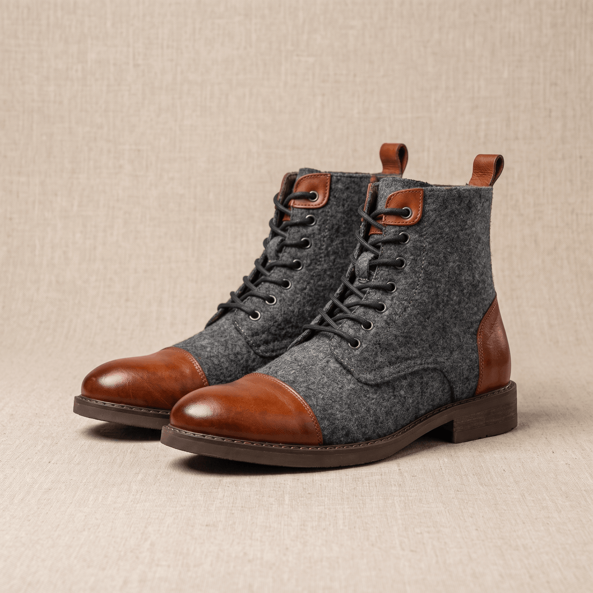 Brown felted wool cap toe boots with polished brown leather trim, seven-eyelet lacing, and a welted sole.