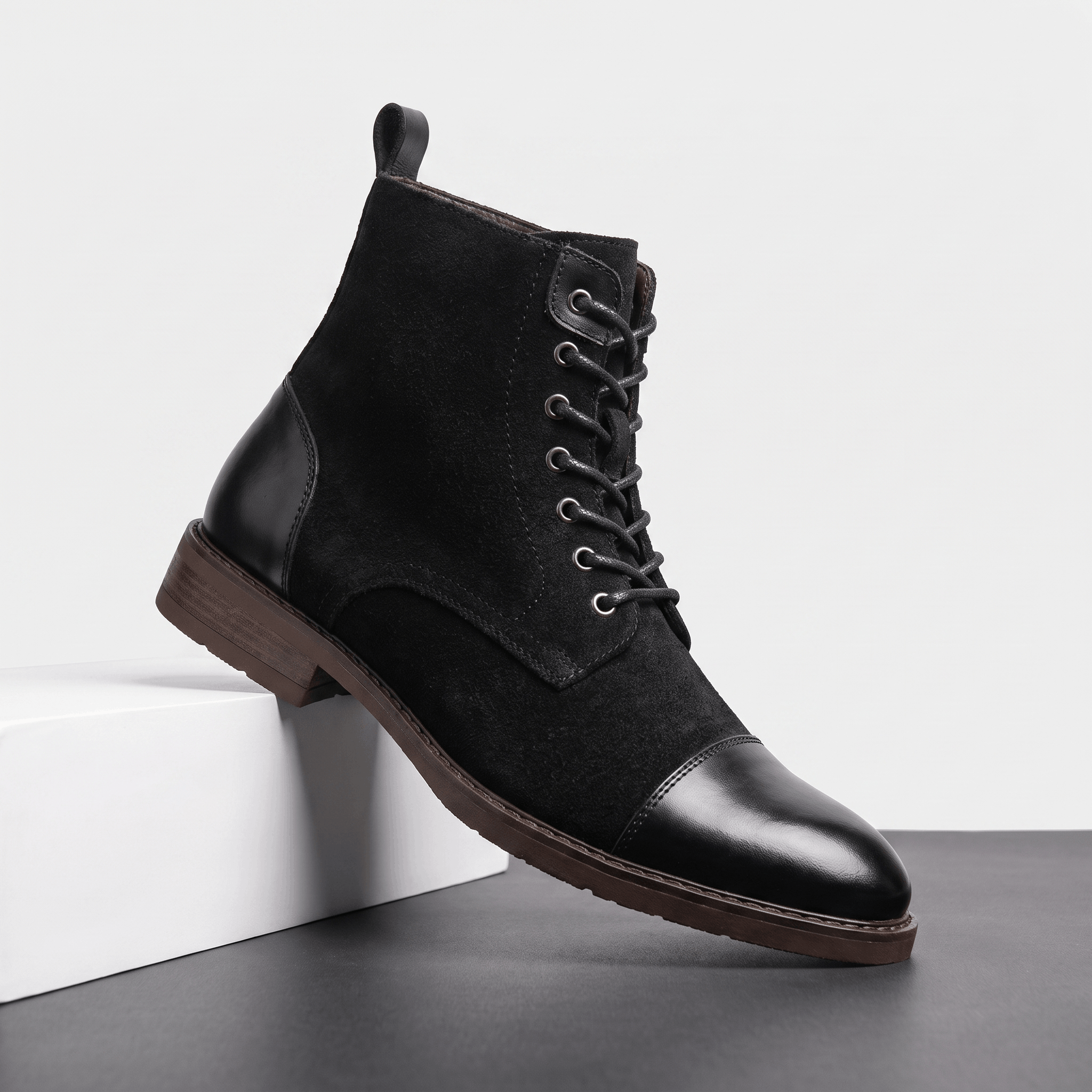 Black lace-up cap toe boot featuring felted wool panels, polished leather trim, and a stacked welted sole.