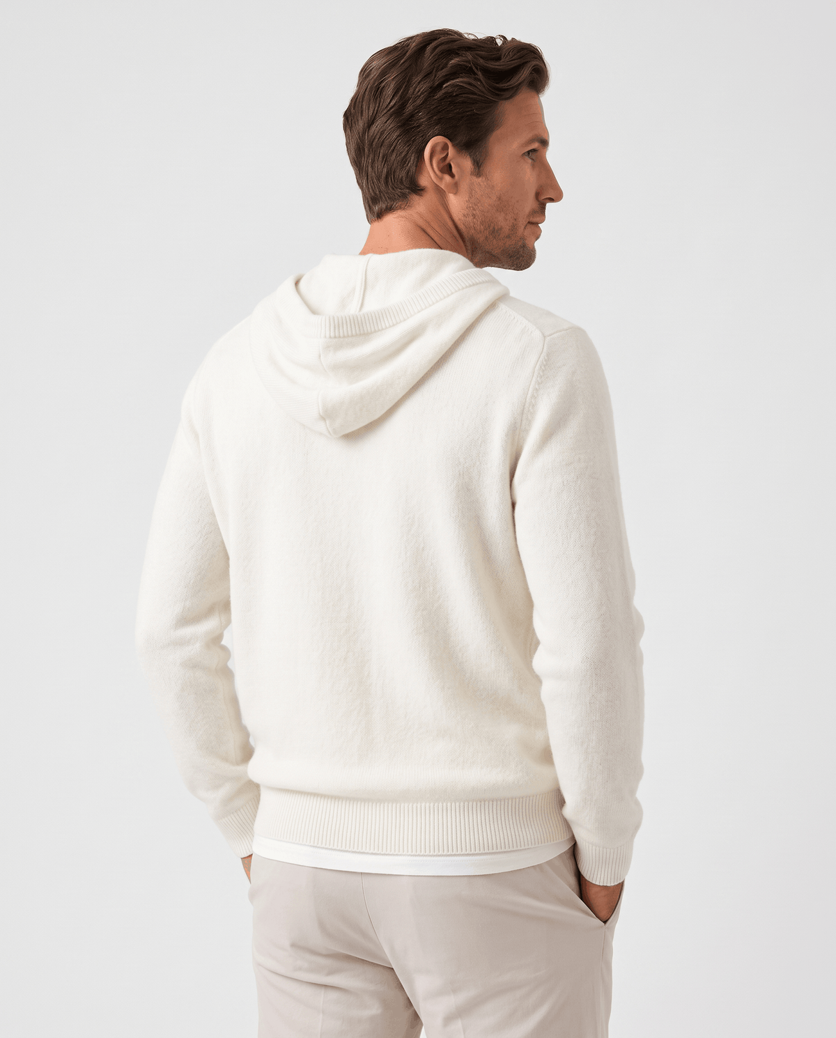 Back view of an ivory fine knit pullover hoodie with the hood down