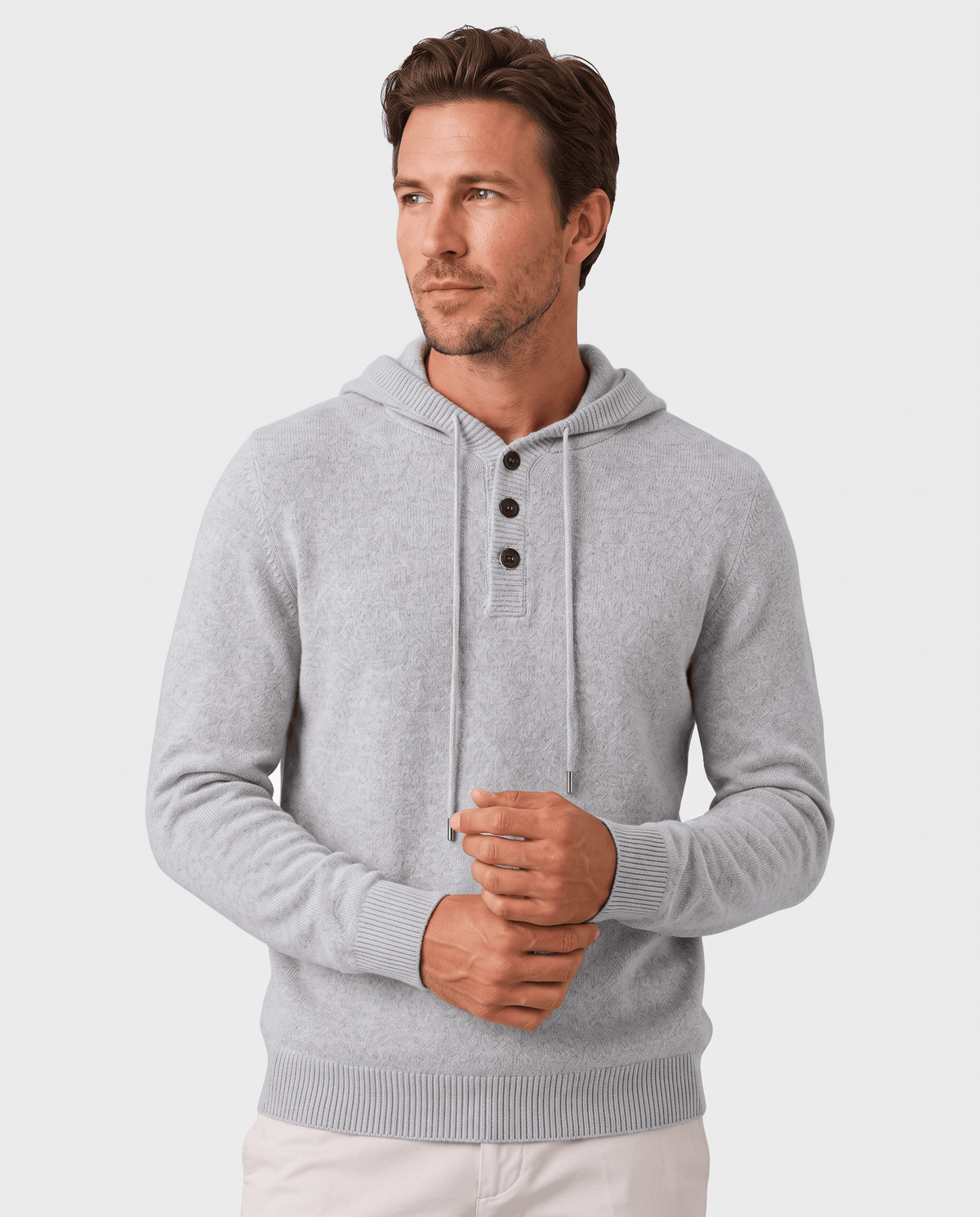 Man wearing a light gray fine knit hoodie with three-button placket, front view