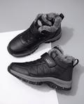 Black insulated lace-up winter boots with a soft fleece lining, padded collar, and rugged lug soles displayed on a white surface.