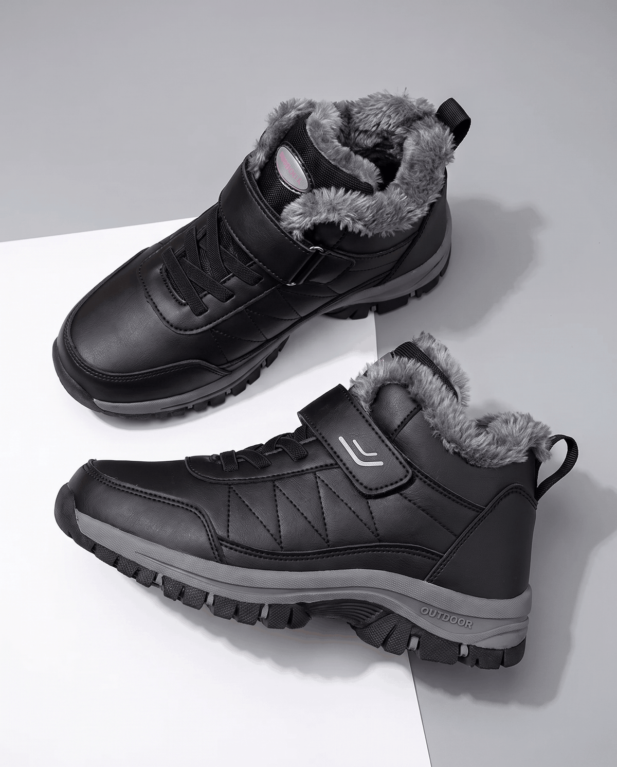Black insulated lace-up winter boots with a soft fleece lining, padded collar, and rugged lug soles displayed on a white surface.