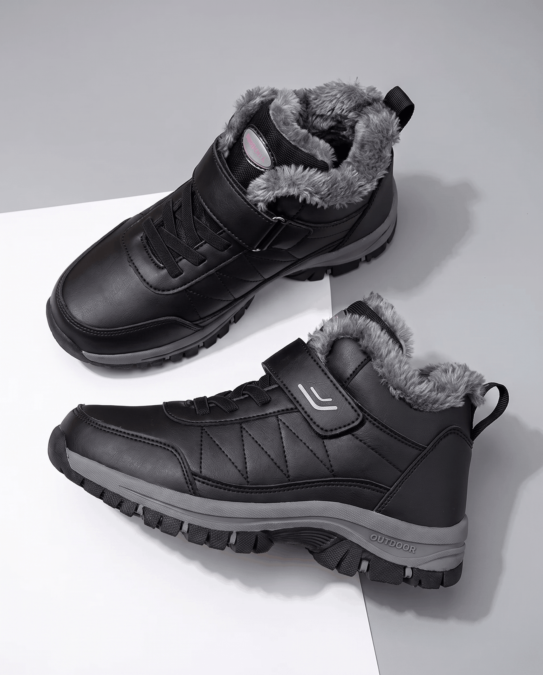 Black insulated lace-up winter boots with a soft fleece lining, padded collar, and rugged lug soles displayed on a white surface.