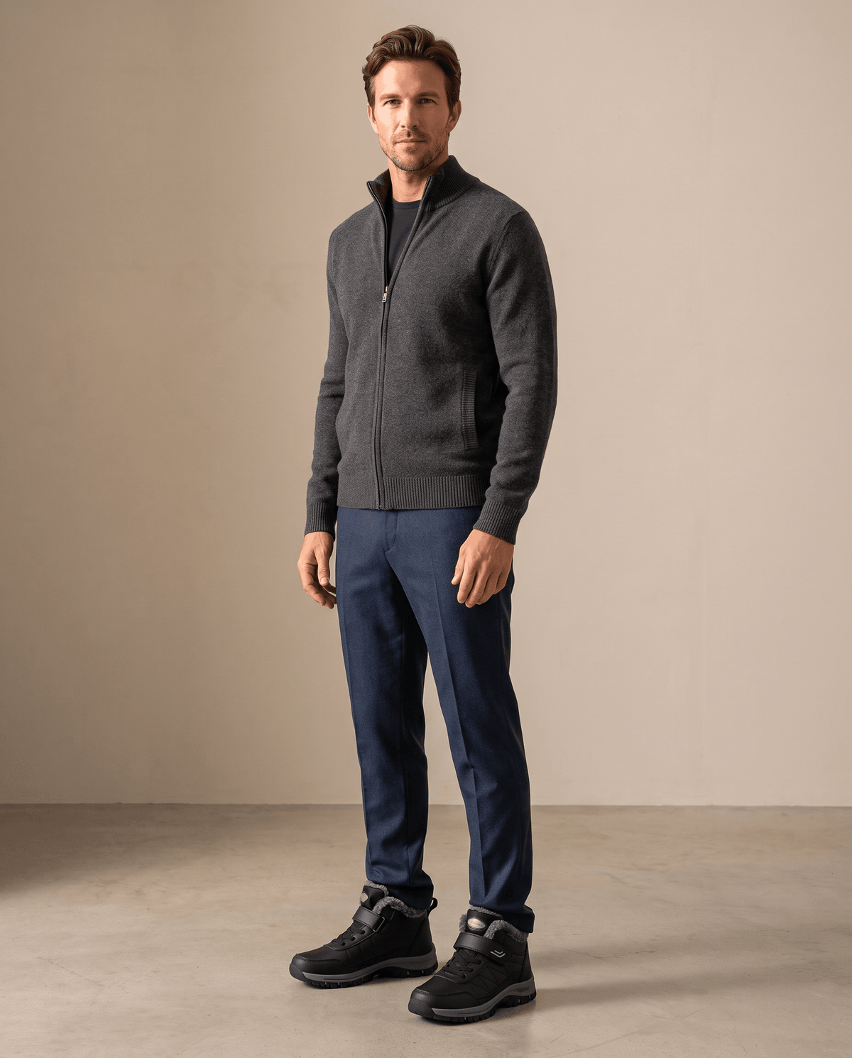 Man wearing black insulated winter boots with a dark jacket and pants.