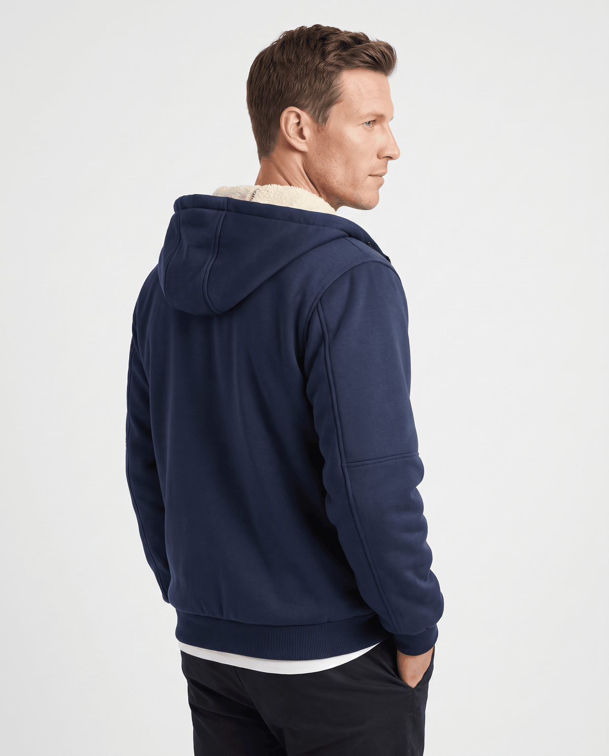 Back of navy blue hooded jacket with fleece lining visible at the collar