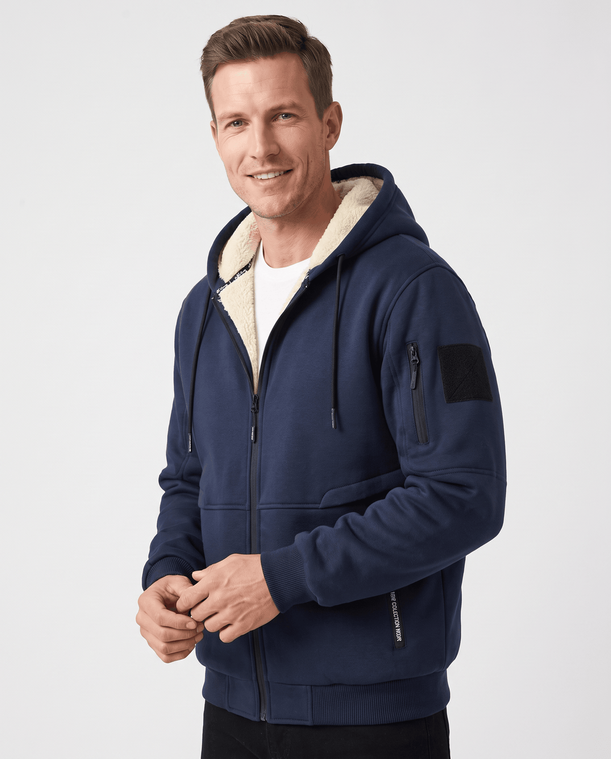 Front view of navy blue hooded jacket with fleece-lined hood and zip pocket on the sleeve