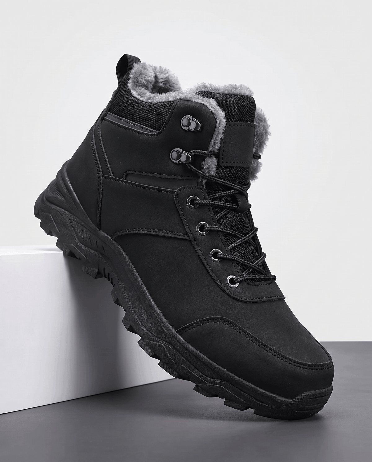 Black insulated lace-up boots shown from a side angle on a white pedestal.