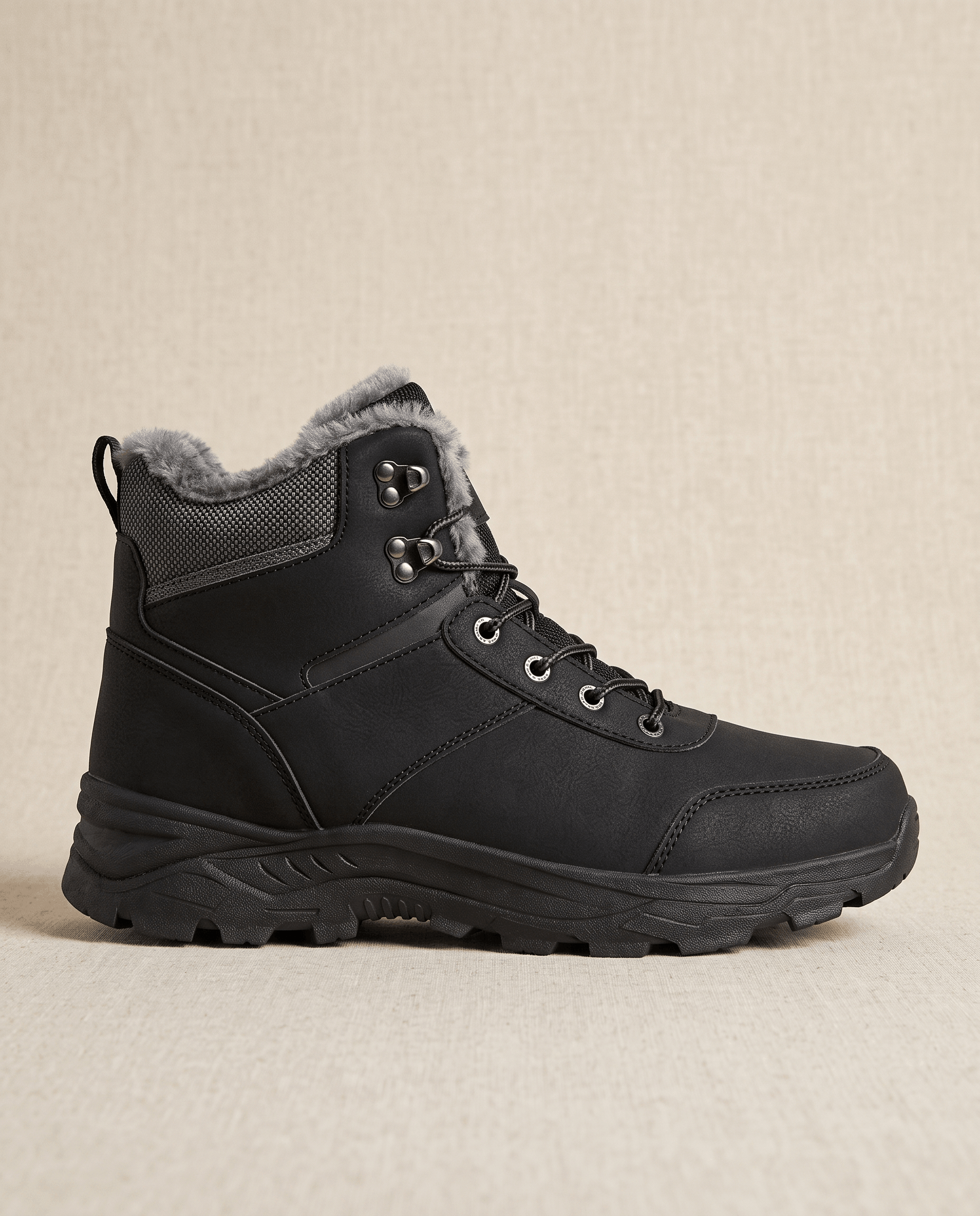 Black winter ankle boot with a padded collar and textured sole on a neutral background.