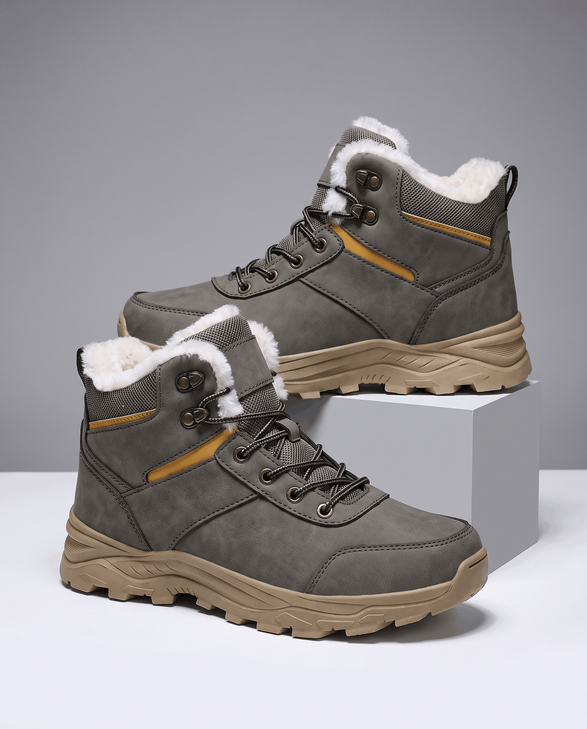 Gray insulated lace-up winter boots displayed against a neutral background.