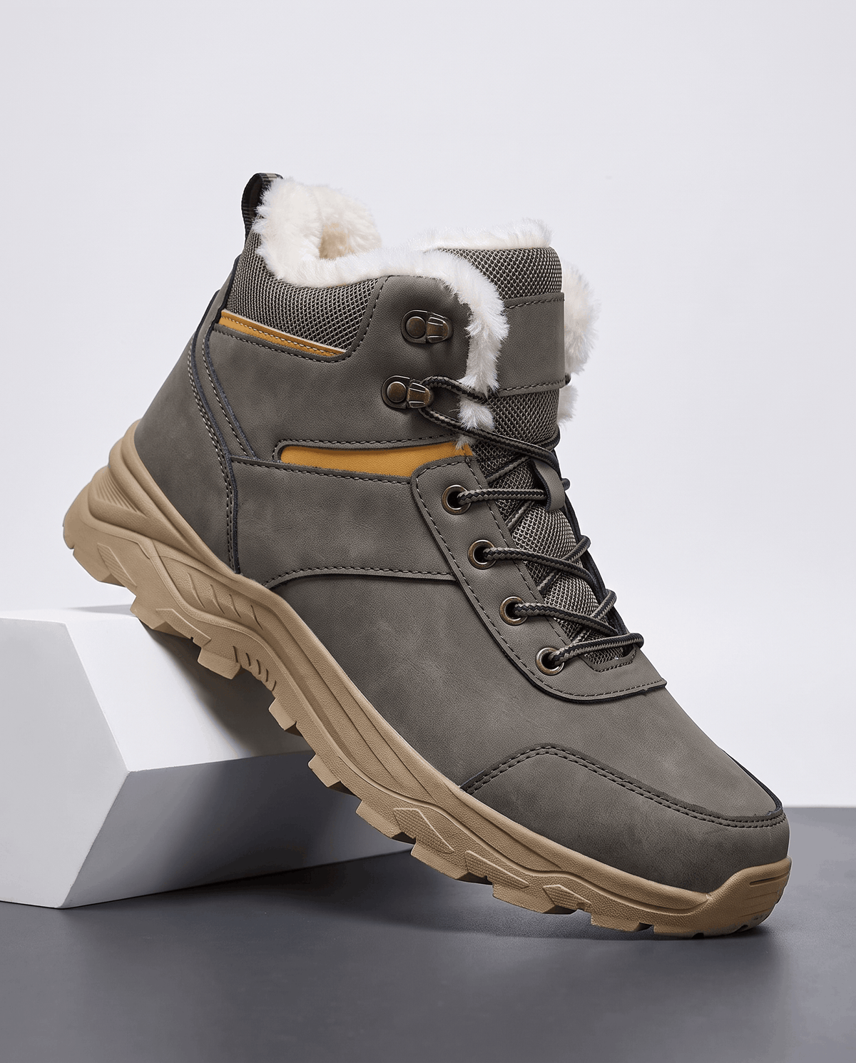 Gray winter boot shown from the side on a white pedestal.