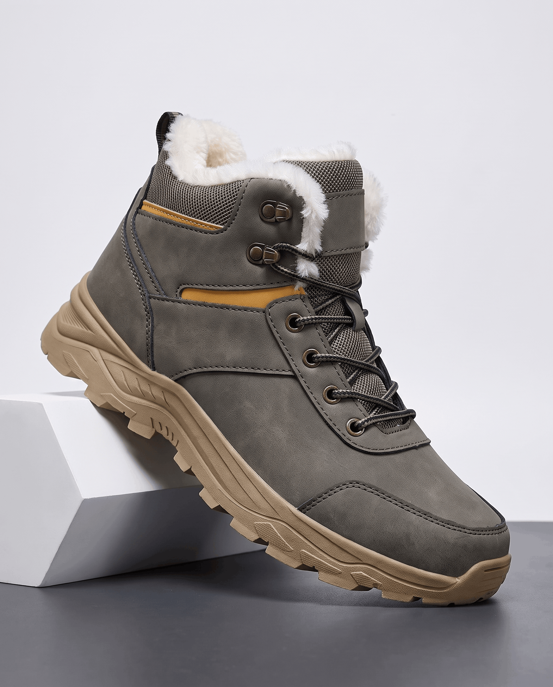 Gray winter boot shown from the side on a white pedestal.