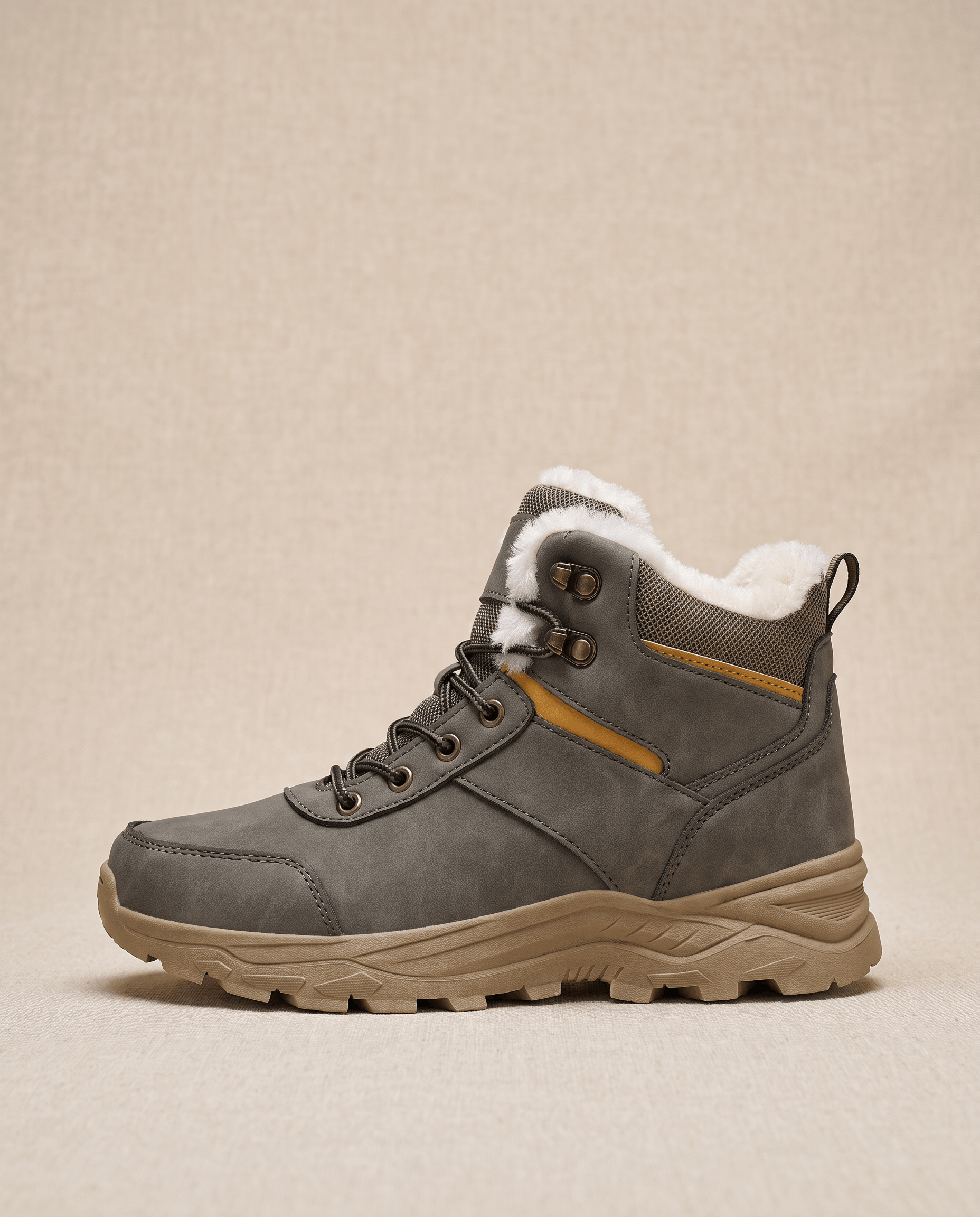Gray insulated winter boot displayed against a beige background.