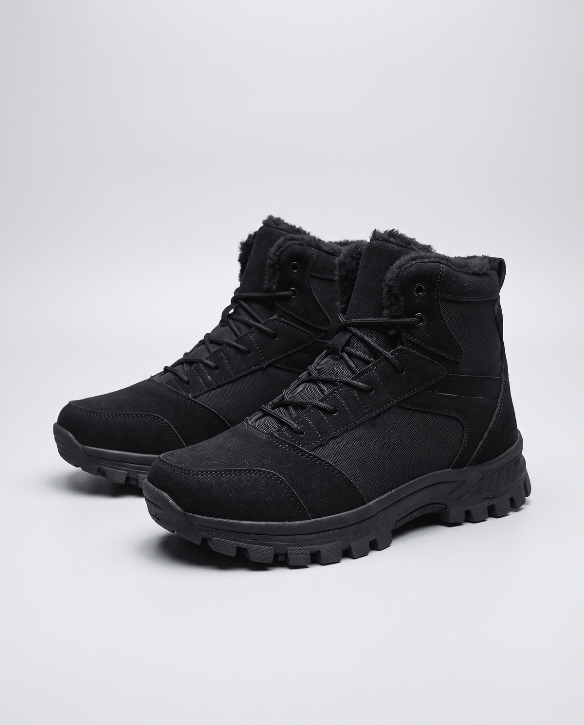 Black pair angled on a light background, suede-look toe and heel overlays