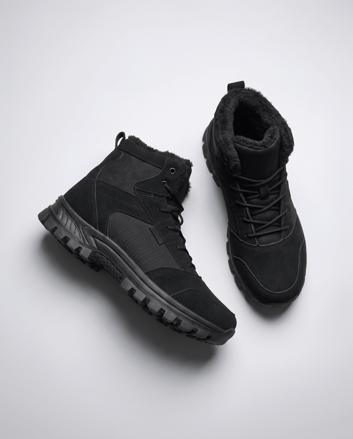 Black boots turned to the side showing the padded collar and lace eyelets