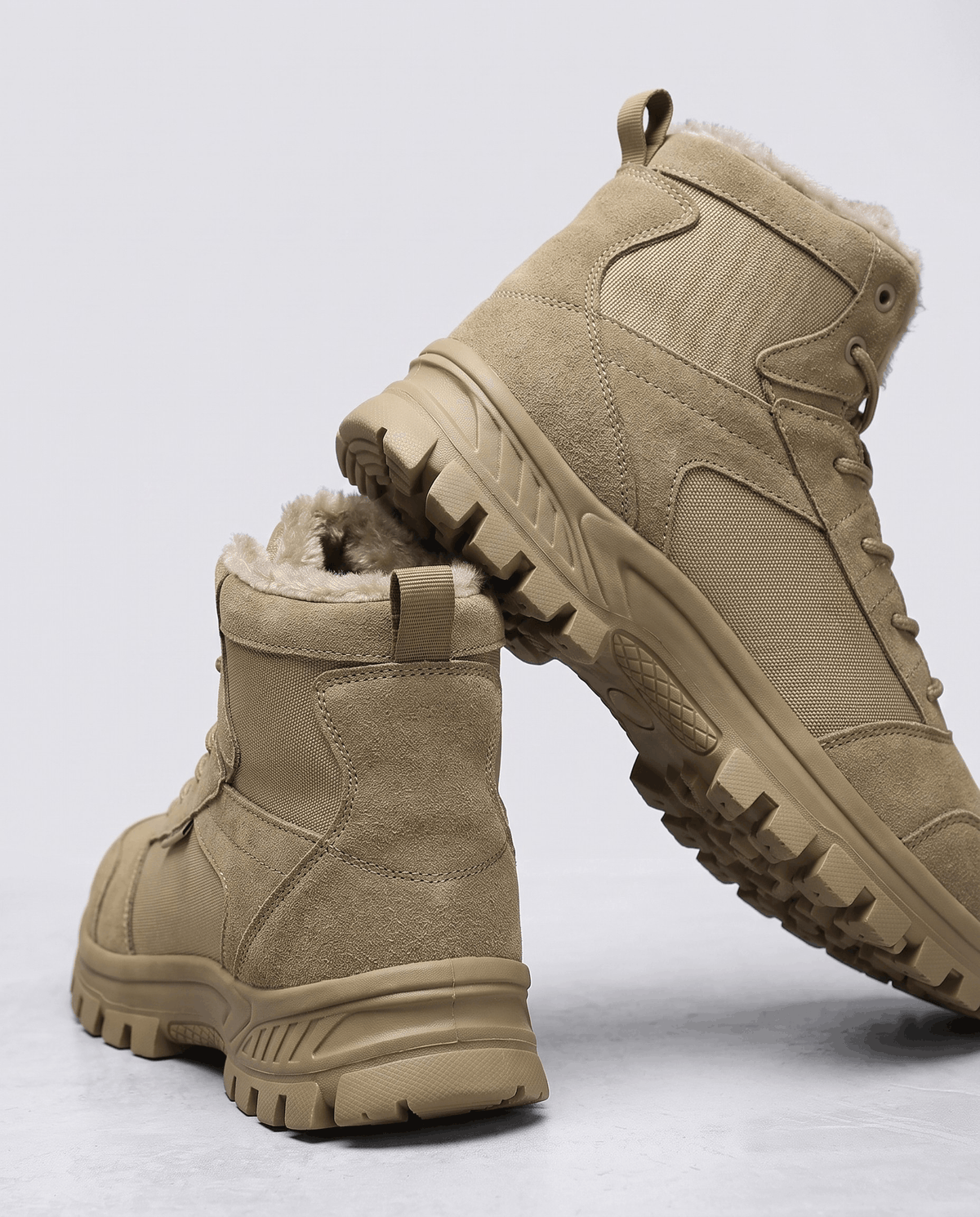 Tan pair with one boot turned to show the deep tread of the outsole