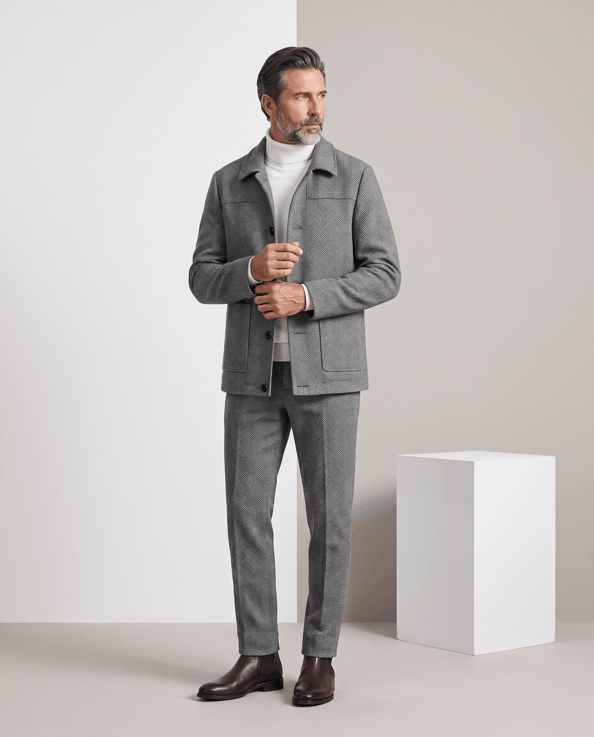 Full-length view of a man wearing the Henrik gray coat with gray trousers