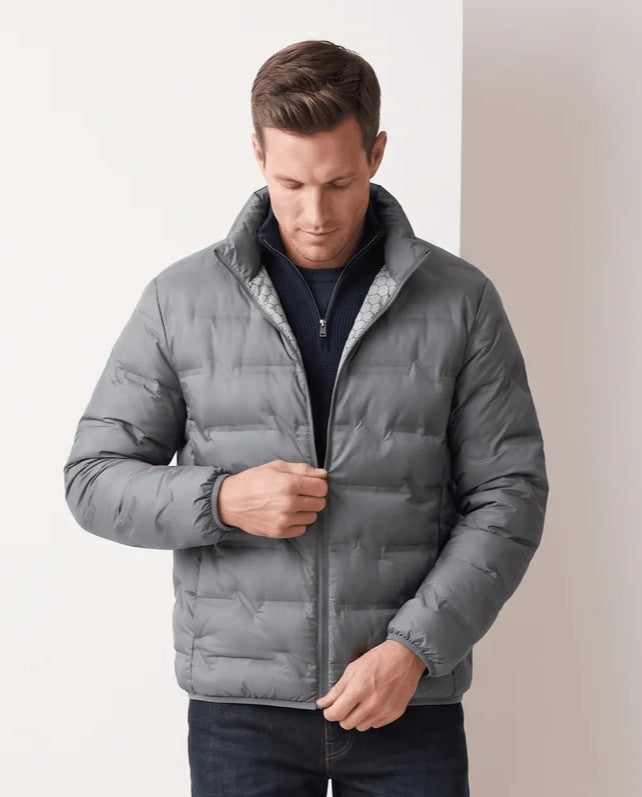 Man wearing a gray quilted duck down puffer jacket with stand collar, front view