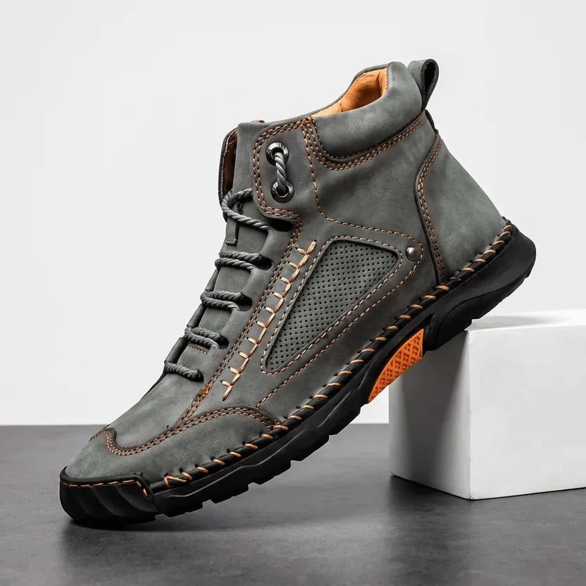 Gray wide toe box hiking boot angled on a white block showing the lug sole