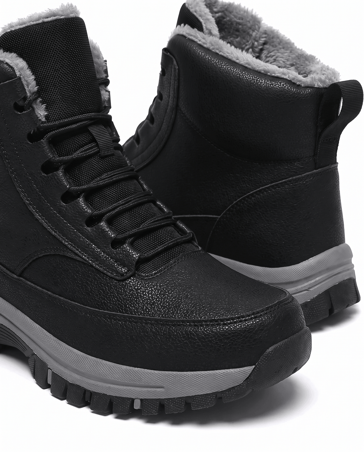 Close view of the black boot's padded collar and upper lace hooks