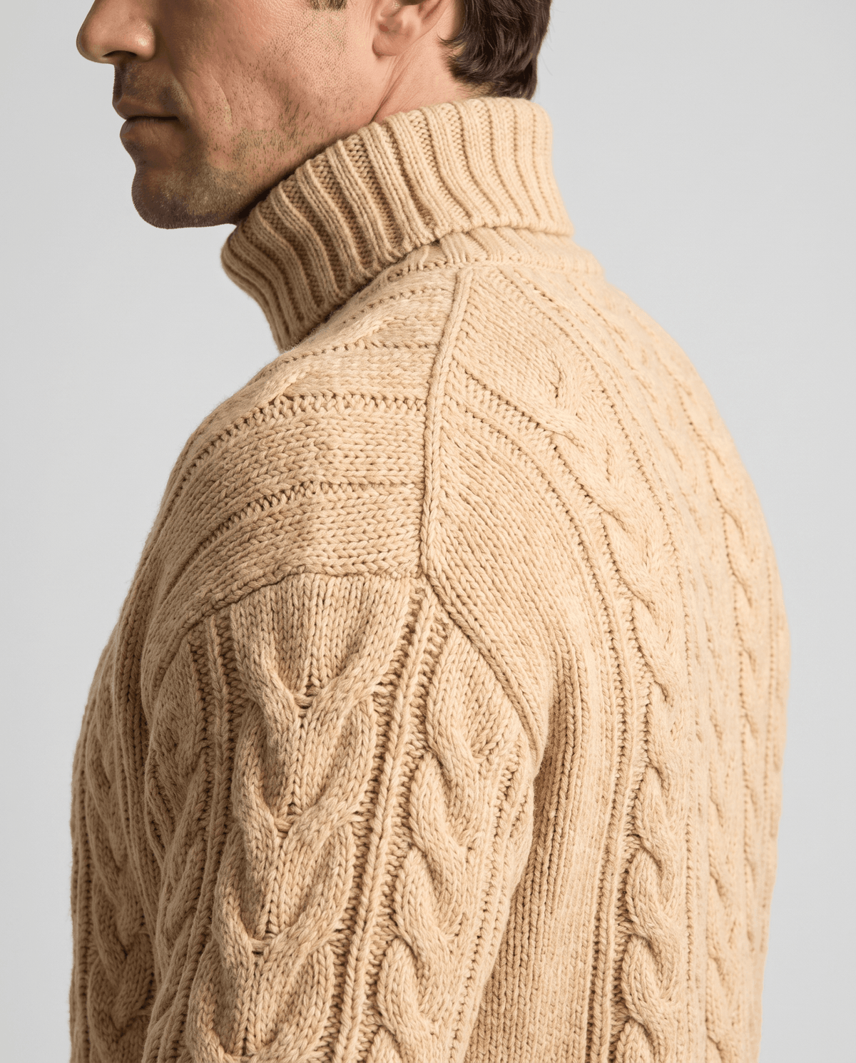 Side profile of sand beige fold-over turtleneck collar and shoulder seam
