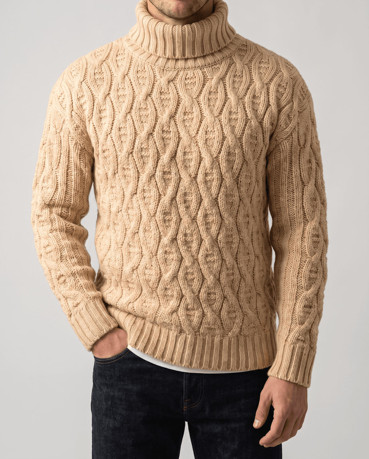 Front close-up of sand beige sweater showing interlocking oval cable columns