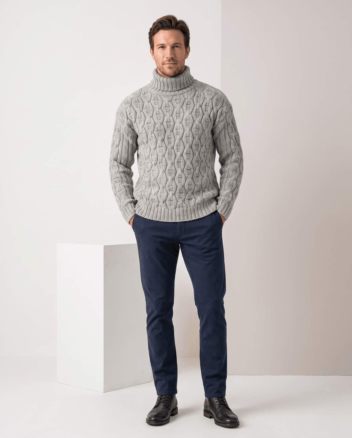 Full-length light gray turtleneck outfit with navy trousers and black leather shoes