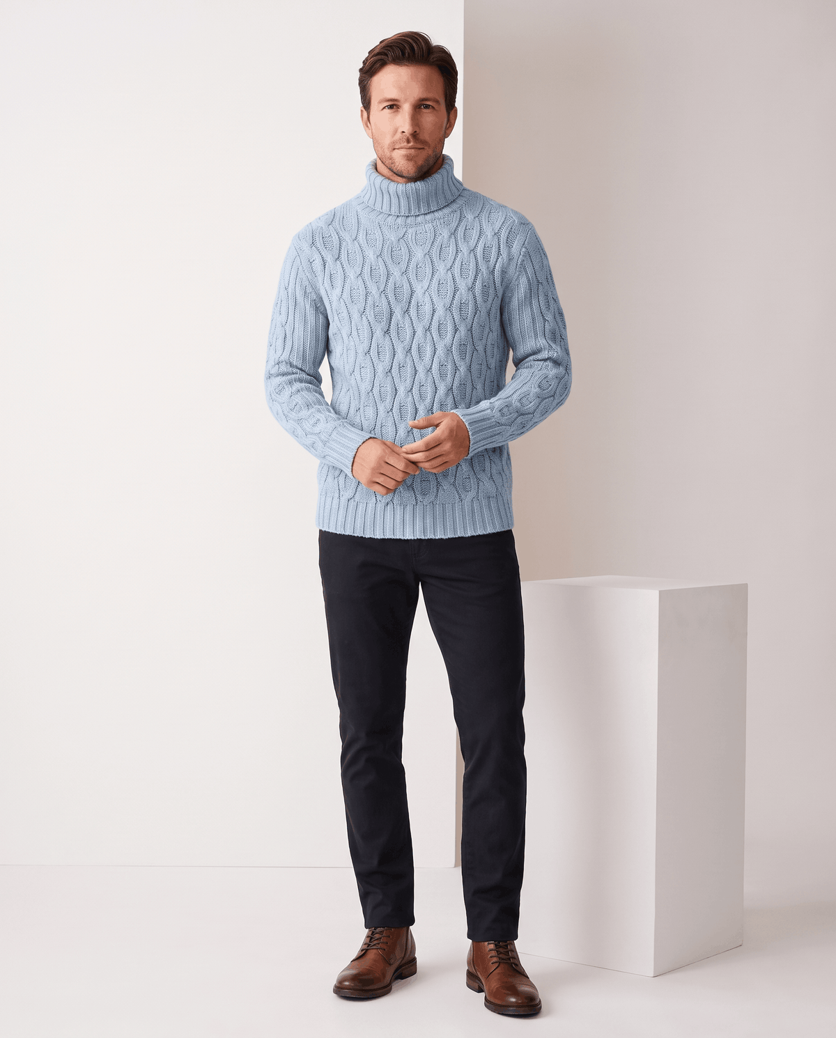 Full-length light blue turtleneck look with black trousers and brown boots