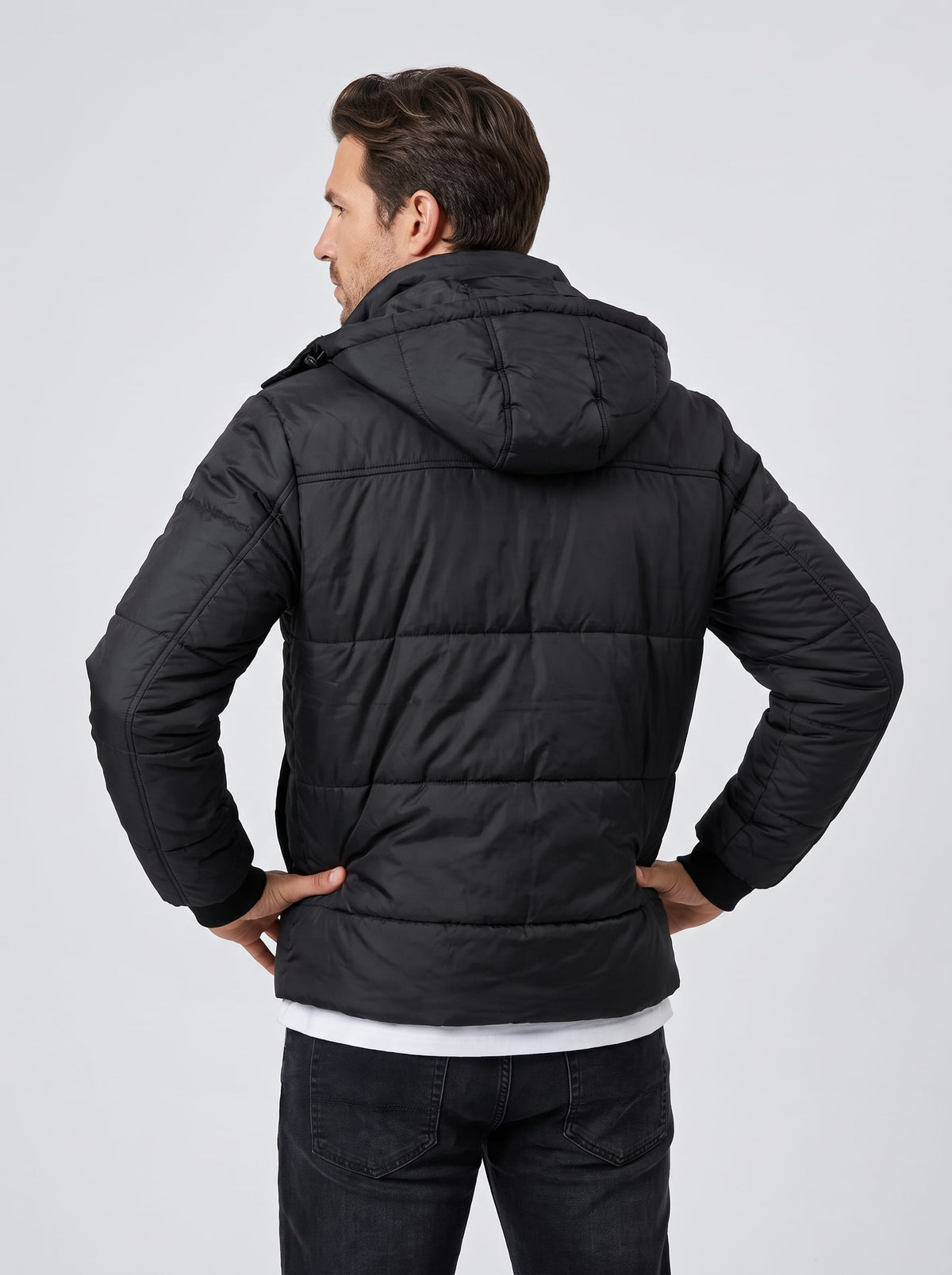Back view in black showing the hood shape and horizontal quilted channels