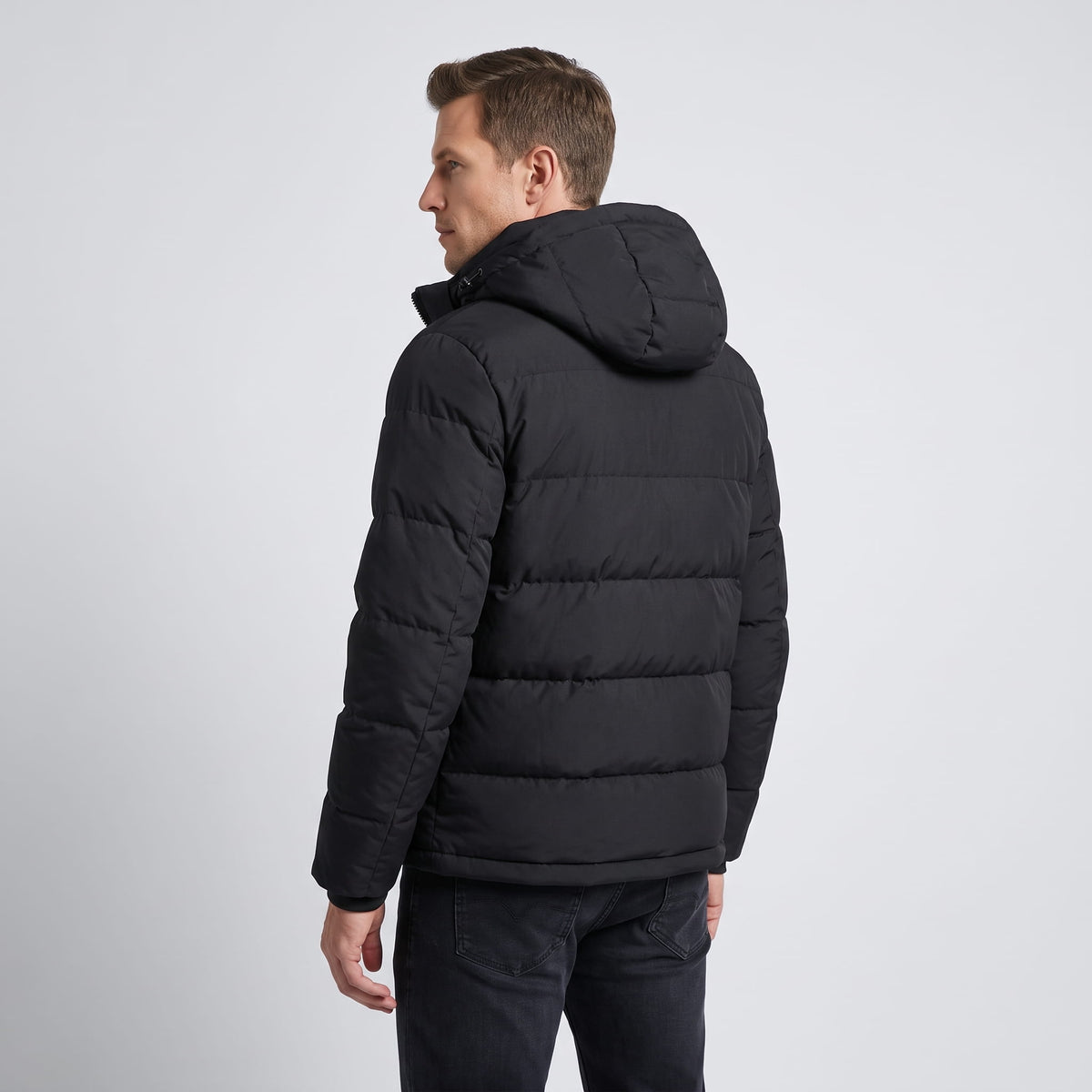 Angled back view in black, showing the hip-length hem and boxy shape