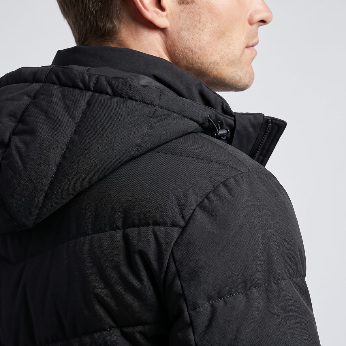 Close view of the black hood and shoulder quilting from behind
