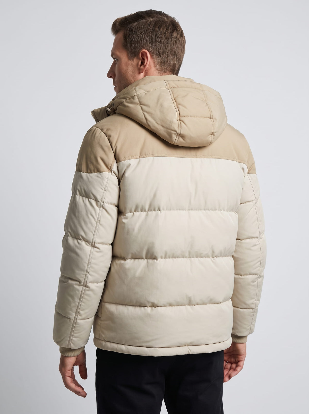 Back view of the cream colorway showing the hood and horizontal quilted rows