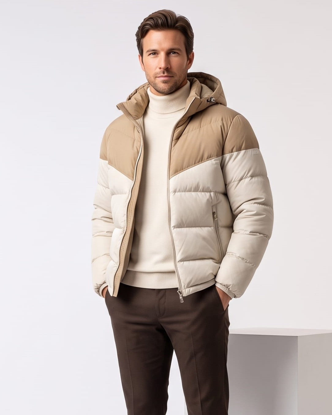 Man wearing cream hooded puffer jacket with tan contrast yoke, worn open