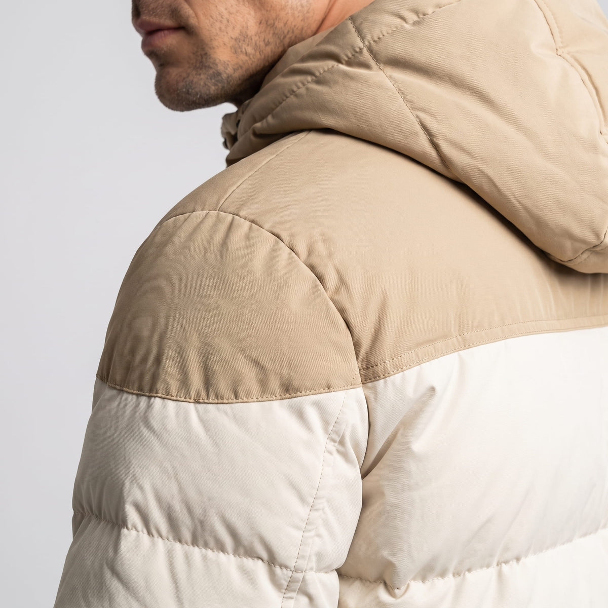 Shoulder detail showing the tan panel meeting the cream body at the yoke seam