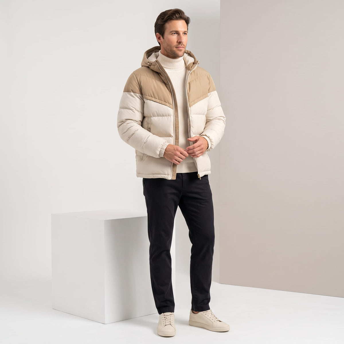 Cream jacket styled full-length with dark jeans and pale sneakers
