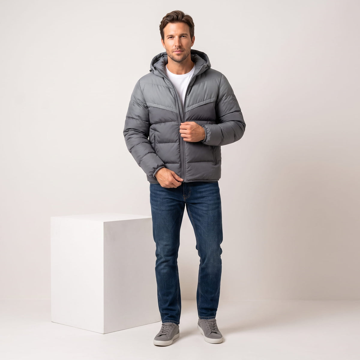 Gray jacket styled full-length with blue jeans and gray sneakers