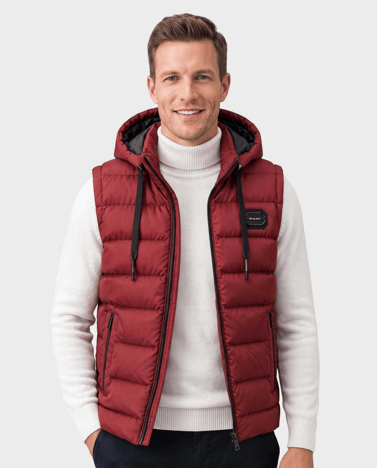 Red hooded quilted vest over a white turtleneck with chest badge and drawstrings
