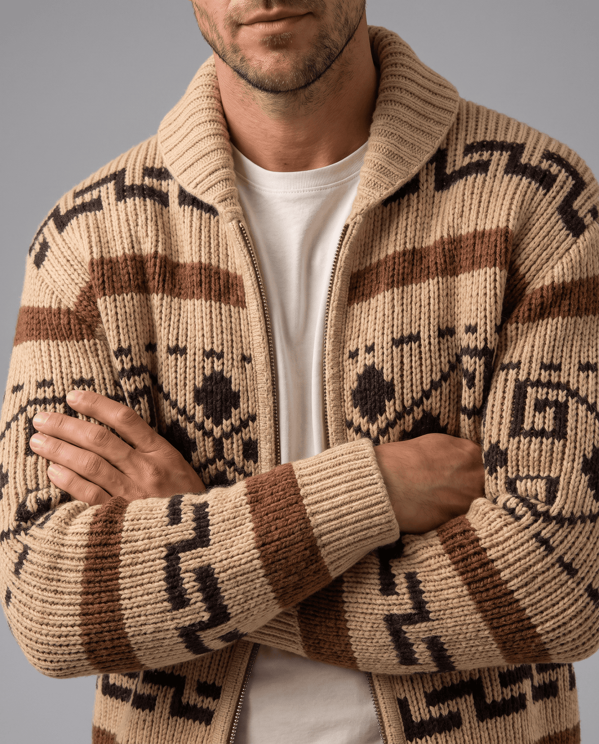 Khaki jacquard cardigan with arms crossed over a white tee, close view of shawl collar