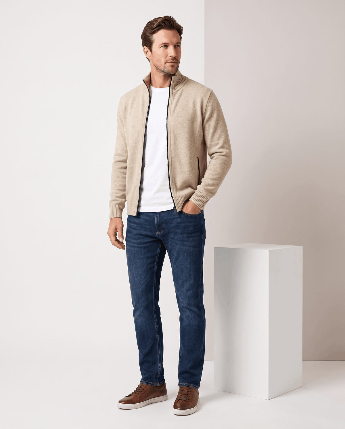Full-length view of the beige zip cardigan with blue jeans and brown shoes