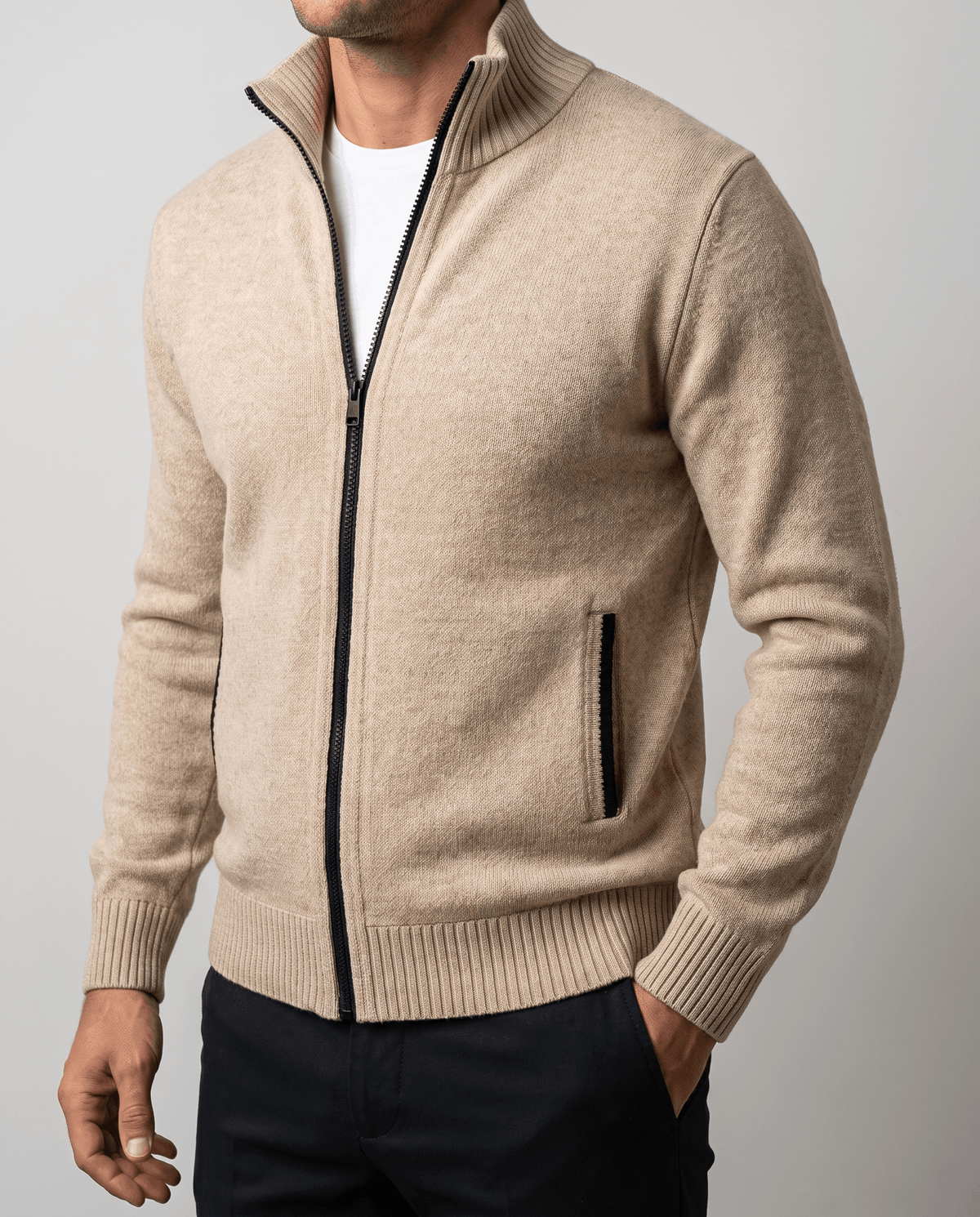 Close-up of the beige cardigan showing the contrast zip and side pocket