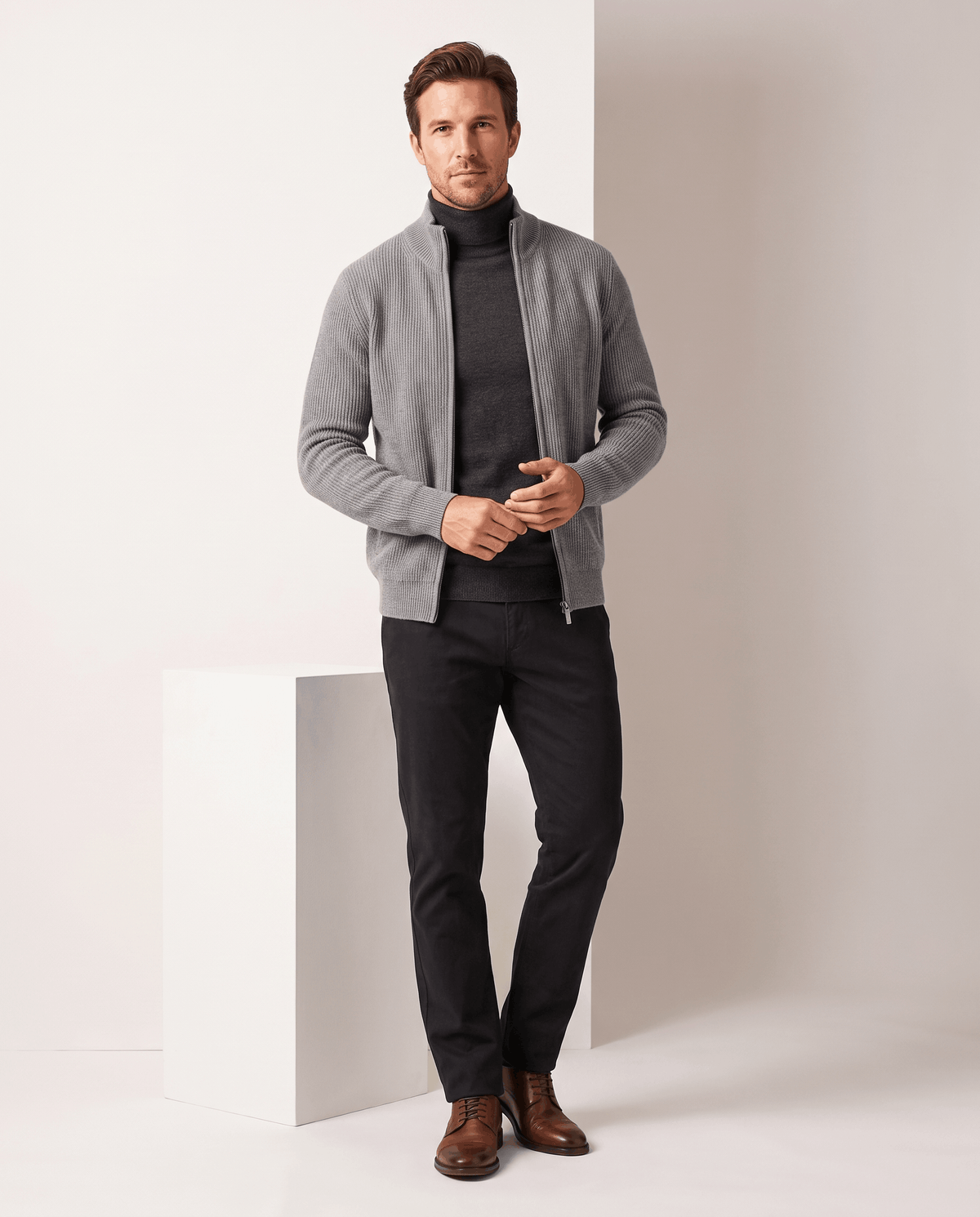Full-length view of the light gray cardigan with black turtleneck and brown shoes